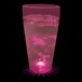 A 20 oz. plastic cup with pink liquid and a pink LED light inside.