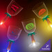 A group of 14 oz. plastic palm tree stem goblets with yellow LED lights.