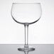 A Libbey Magna Grande margarita glass with a stem on a table.