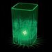 A 2 oz. green plastic square shot cup with a light in the middle.