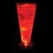 A customizable plastic pilsner cup with red liquid and a red LED light.