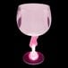 A pink plastic guitar stem goblet with a pink handle.