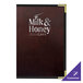 A brown leather H. Risch menu cover with the words "Milk and Honey Cafe" on the front.