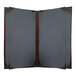 A grey rectangular H. Risch, Inc. wine menu cover with a brown leather border and picture corners.