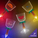 A group of customizable plastic stem wine cups with palm tree stems and blue LED lights.