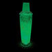 A customizable plastic shaker filled with a green drink and lit by a green LED light.