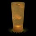 A 10 oz. customizable plastic cup with a yellow LED light filled with liquid and ice.