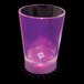 A customizable plastic shot cup with a purple LED light on a bar counter.