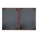 A brown and black H. Risch, Inc. leather menu cover with picture corners.