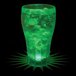 A 12 oz. plastic soda cup with a green drink and ice in it with a green LED light.