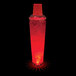 A 32 oz. plastic shaker with red LED lights filled with a red drink and ice.