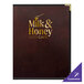 A brown leather H. Risch, Inc. menu cover with the Milk & Honey Cafe logo in gold on a table.