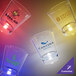A close-up of a customizable plastic shot glass with a blue LED light. Several customizable plastic shot glasses with different logos.