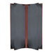 A black rectangular H. Risch, Inc. Tuxedo leather menu book with brown corners on a wooden table.
