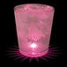 A customizable plastic rocks cup filled with pink liquid and ice with a pink LED light shining on it.
