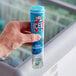 A hand holding a blue tube of ICEE Blue Raspberry Freeze