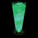 A 12 oz. customizable plastic pilsner cup with a green drink in it.