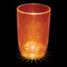 A close-up of a customizable plastic stemless wine cup with an orange LED light inside.