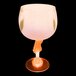 A close-up of a customizable plastic guitar stem goblet with an orange base and pink top with an orange LED light.