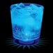 A blue drink in a customizable plastic rocks cup with blue LED light and ice.