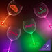 A group of customizable plastic goblets with green LED lights on a table.