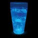 A customizable plastic cup with blue LED lights filled with a blue drink and ice.