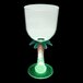 A clear plastic goblet with a palm tree stem and a green LED light.