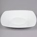 A white square porcelain plate with a coupe shape.