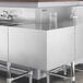A Regency stainless steel 90-degree angle underbar filler on a stainless steel counter in a professional kitchen.
