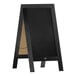 A vintage black wood A-frame chalkboard with a black chalkboard.