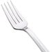 A close-up of a WNA Comet Reflections stainless steel look plastic fork with a silver handle.