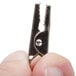 A hand using a silver American Metalcraft double-sided flexible sign clip to hold a card.