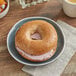 A honey wheat bagel with cream cheese on a plate.
