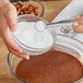 A person stirring Regal Erythritol into a bowl of brown liquid.