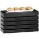 A black rectangle crate riser with a tray of cookies on it.