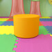 A yellow circle sits on a colorful surface.