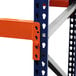 An orange and blue Interlake Mecalux heavy-duty metal pallet rack beam.