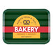 A green Cambro rectangular tray with a yellow and white bakery logo.