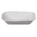 A white rectangular Huhtamaki Chinet molded fiber food tray with food.