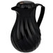 A black plastic pitcher with a handle.