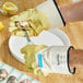 A person wearing Cordova Ruffian rubber gloves using a knife to shuck oysters.