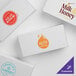 A group of white 7 1/8" x 3 3/8" x 1 7/8" candy boxes with logos.