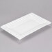 A white rectangular porcelain platter with a decorative edge.