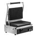 A Vollrath stainless steel panini grill with black and silver accents on a counter.