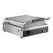 A large stainless steel panini grill with smooth aluminum plates and a handle, designed for commercial use.