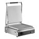 A large stainless steel panini grill with smooth aluminum plates and a hinged top lid.