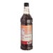 A close-up of a Monin Maple Pumpkin Cold Brew Coffee 7:1 Concentrate bottle with a label.