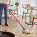 A person mopping the floor with a Lavex Wet Mop.