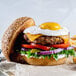 A burger with a Yo Egg Plant-Based Sunny Side Up Egg on top.