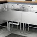 A Regency stainless steel underbar hand sink with a faucet above a drain.